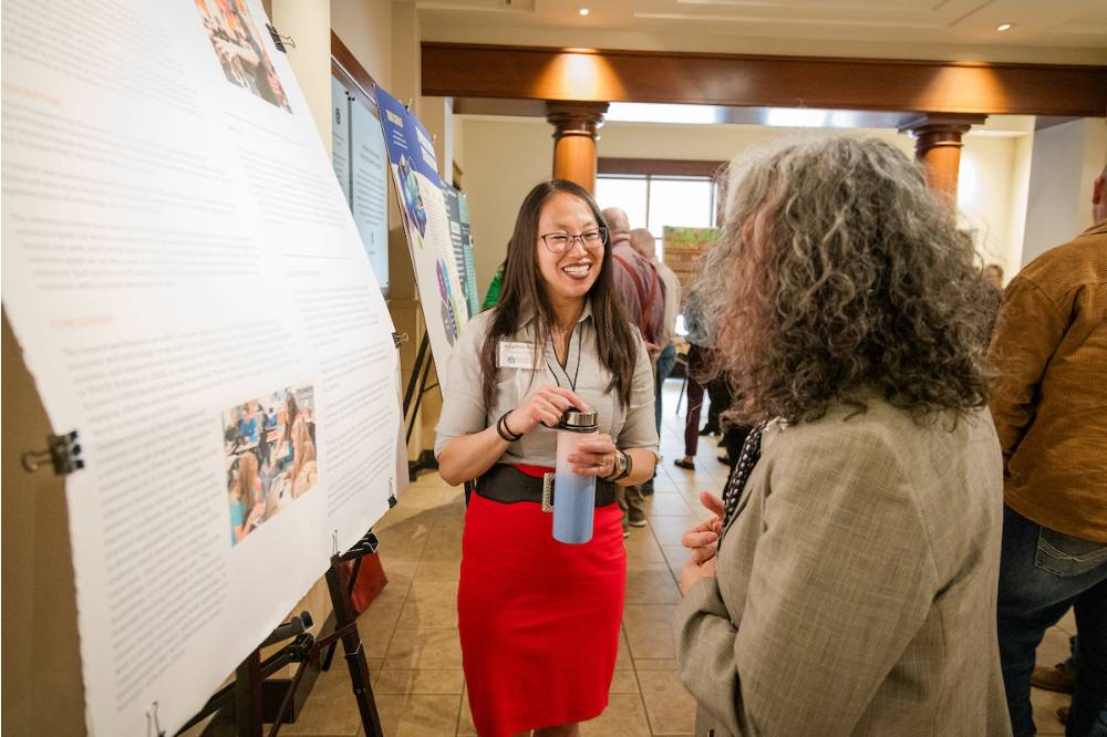 Angelina (left) happily explaining her research